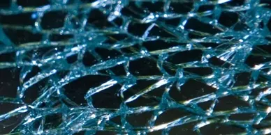A close up of the shattered glass on a car.