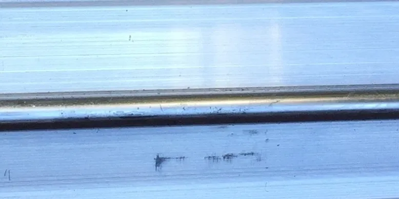 A blurry image of the side of a train.