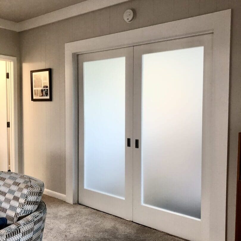 A room with two doors and a couch