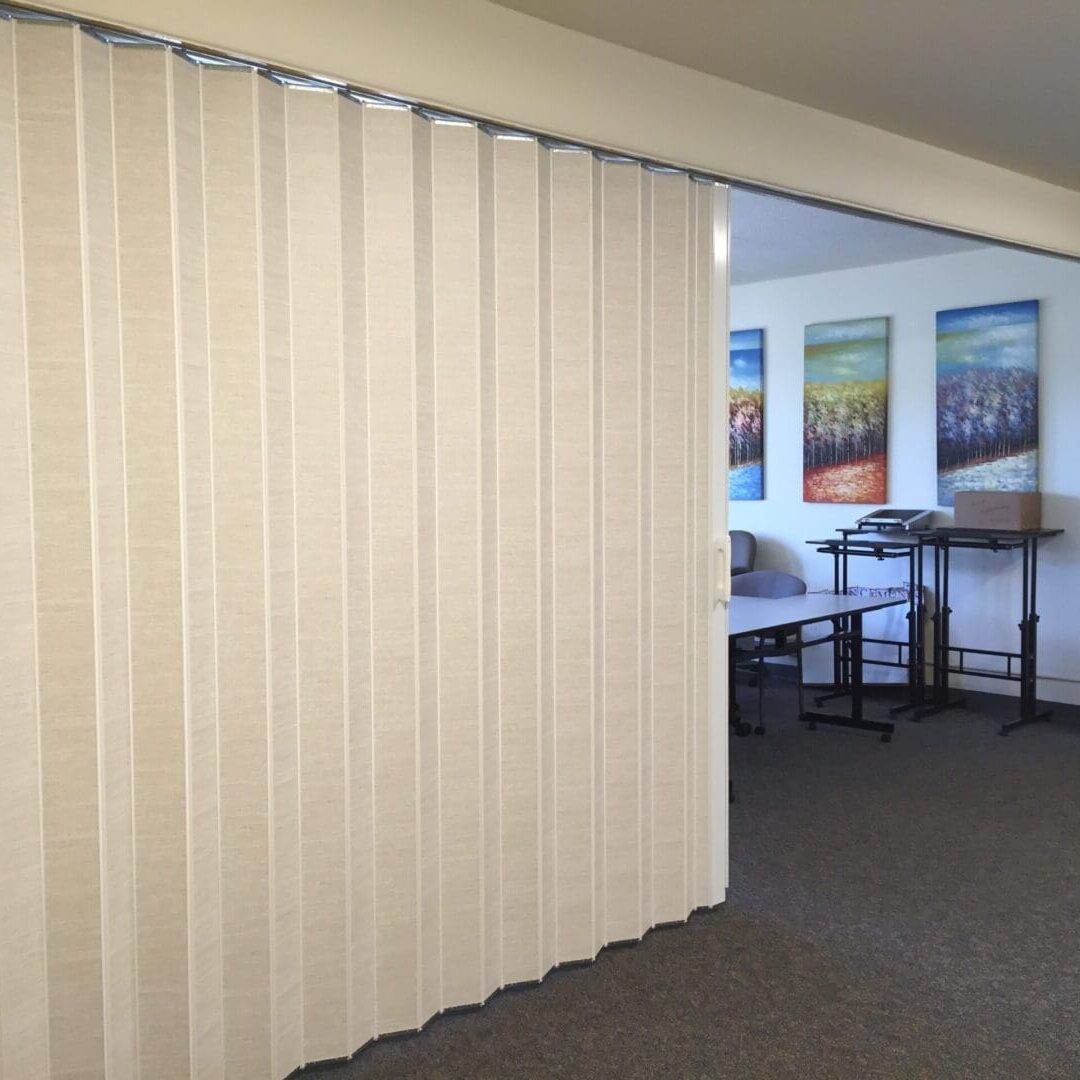 A room with a white curtain and a table
